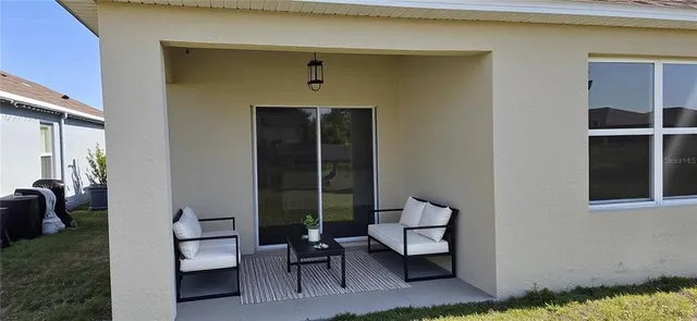 a view of two chairs in a patio