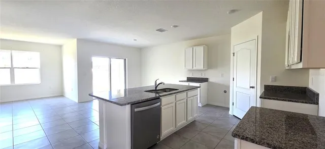a kitchen with stainless steel appliances granite countertop a stove and a sink