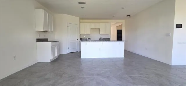 a kitchen with cabinets and a stove top oven