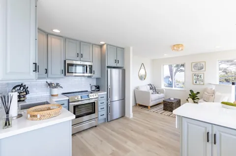 a kitchen with a sink stove and refrigerator