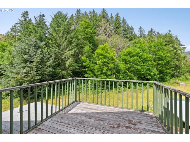 a view of balcony with wooden floor and fence