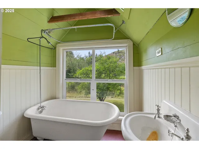 a white bath tub sitting next to a window