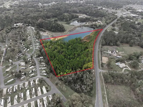 an aerial view of lake residential house and ocean view
