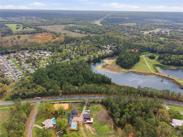 an aerial view of a houses with a yard