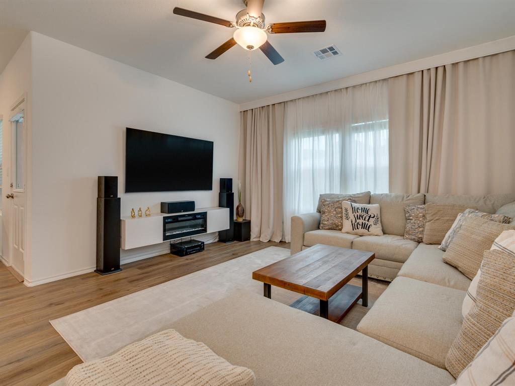 1208 Sweetspire Street Leander, TX 78641 - Photo 12 of 36 Spacious living area featuring light wood-finish flooring and a ceiling fan