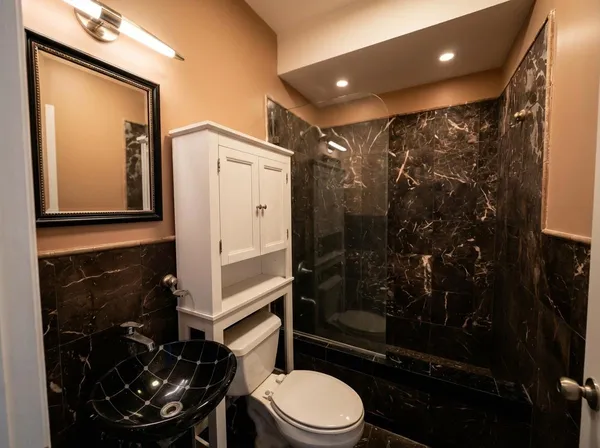 a bathroom with a toilet a sink and shower