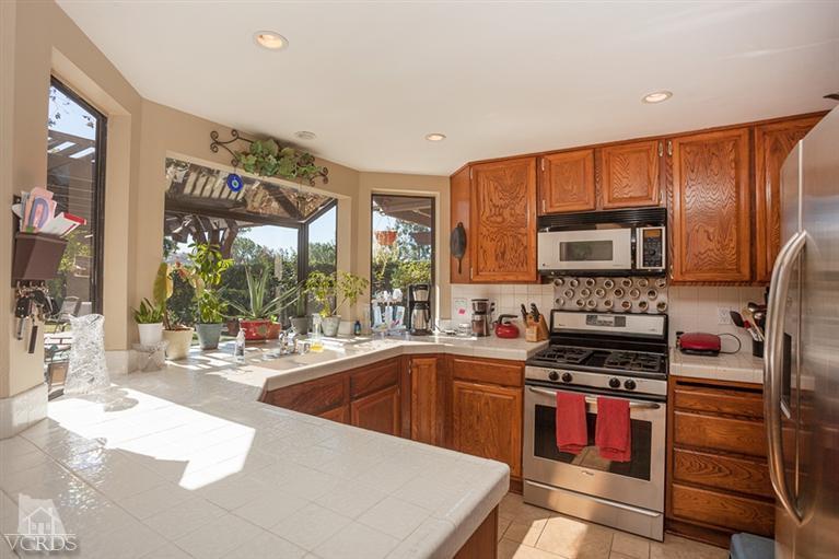 13648 Laurelhurst Road Moorpark, CA 93021 - Photo 12 of 32 a kitchen with stainless steel appliances granite countertop a stove top oven a sink and dishwasher