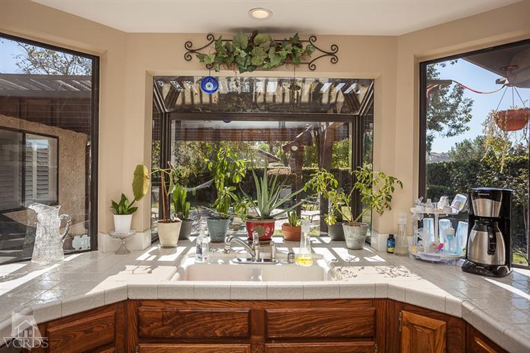 13648 Laurelhurst Road Moorpark, CA 93021 - Photo 13 of 32 a kitchen with sink and a large mirror