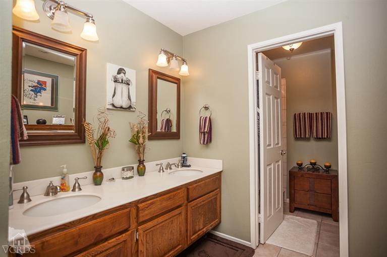 13648 Laurelhurst Road Moorpark, CA 93021 - Photo 16 of 32 a en suite bathroom with a double vanity sink and mirror