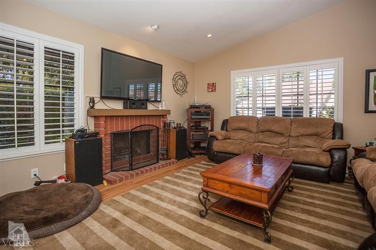 13648 Laurelhurst Road Moorpark, CA 93021 - Photo 4 of 32 a living room with furniture a flat screen tv and a fireplace