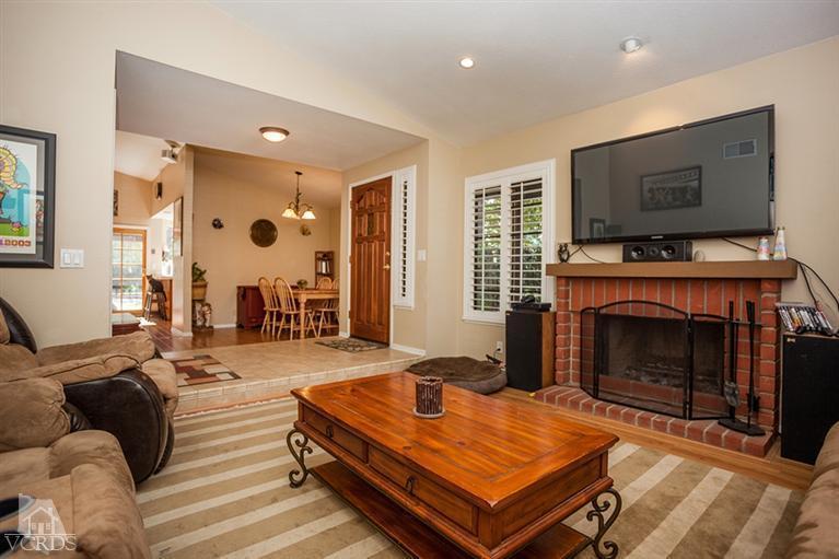 13648 Laurelhurst Road Moorpark, CA 93021 - Photo 6 of 32 a living room with furniture a flat screen tv and a fireplace