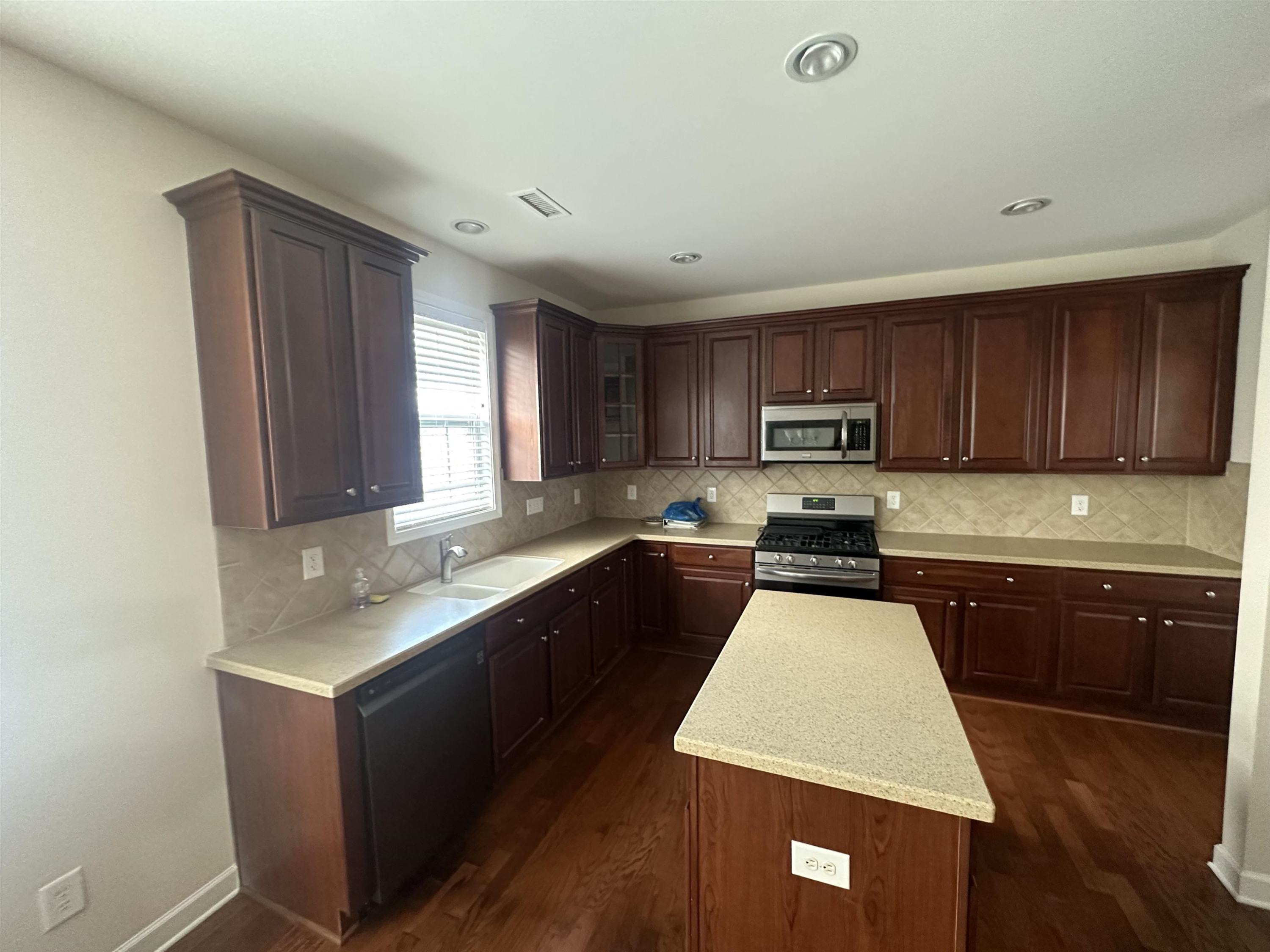 5161 Holly Ridge Farm Road Raleigh, NC 27616 - Photo 11 of 35 a kitchen with granite countertop wooden cabinets a sink and dishwasher