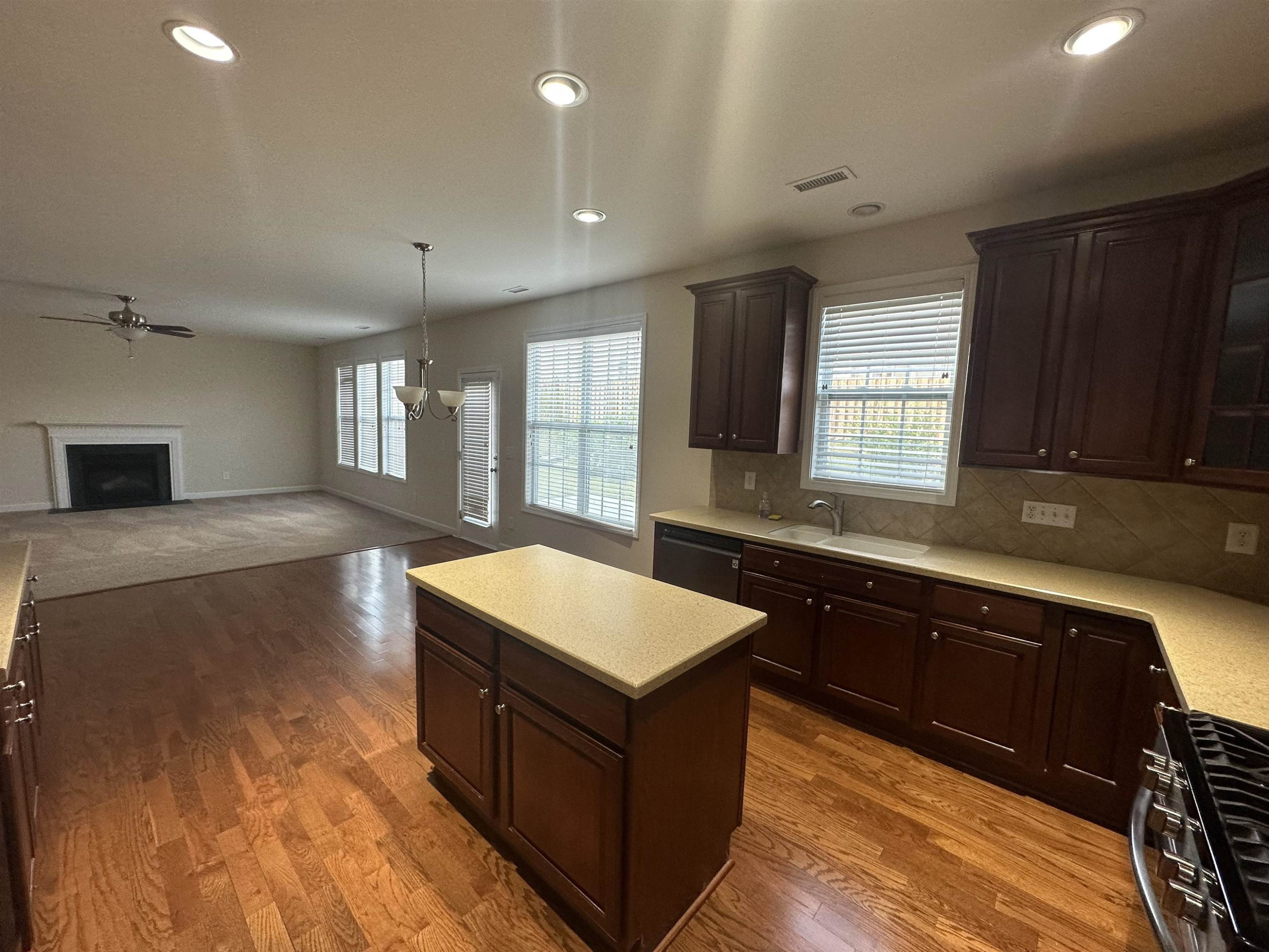5161 Holly Ridge Farm Road Raleigh, NC 27616 - Photo 13 of 35 a large kitchen with wooden floors and a sink