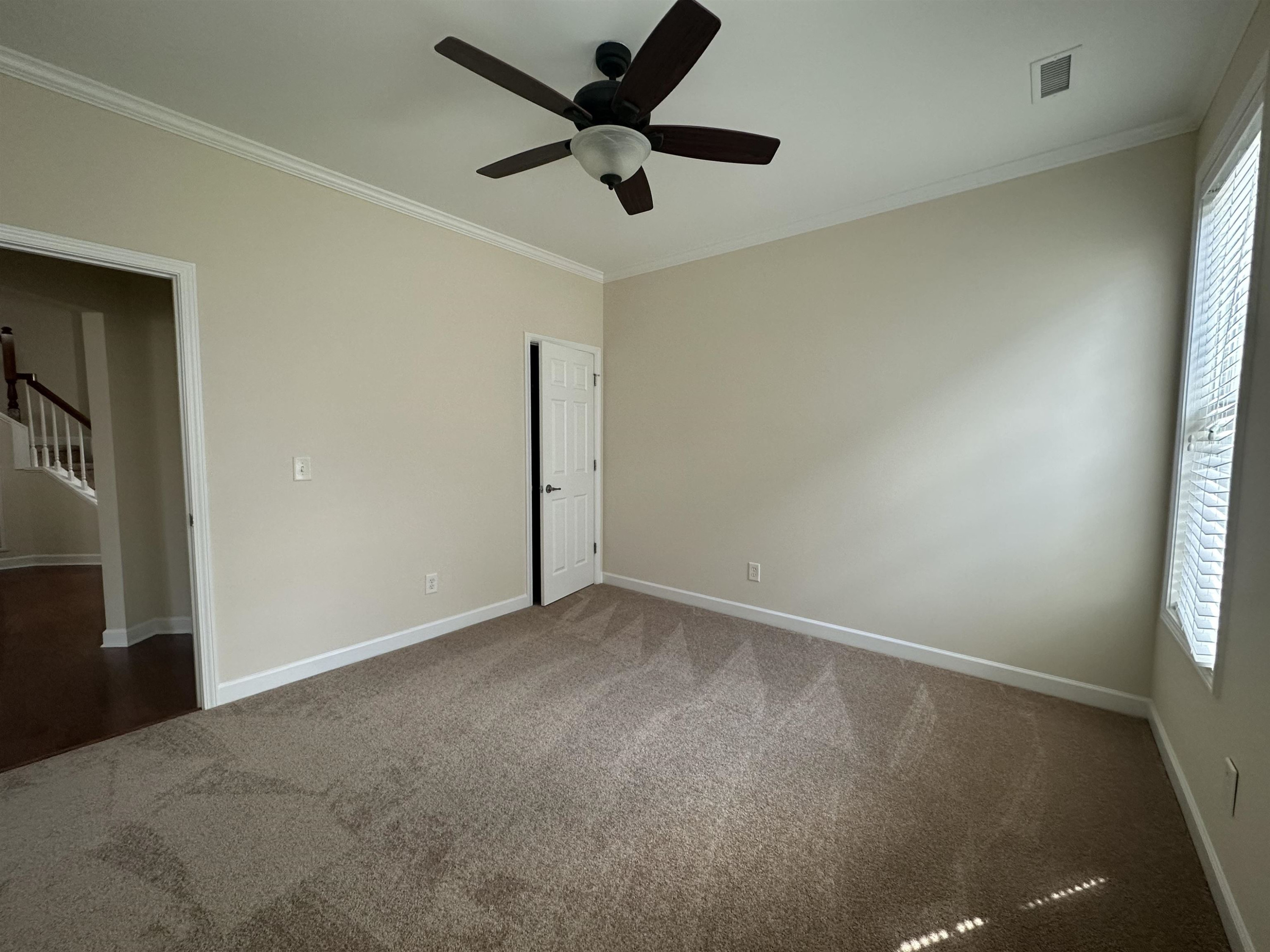 5161 Holly Ridge Farm Road Raleigh, NC 27616 - Photo 16 of 35 an empty room with a window and a fan