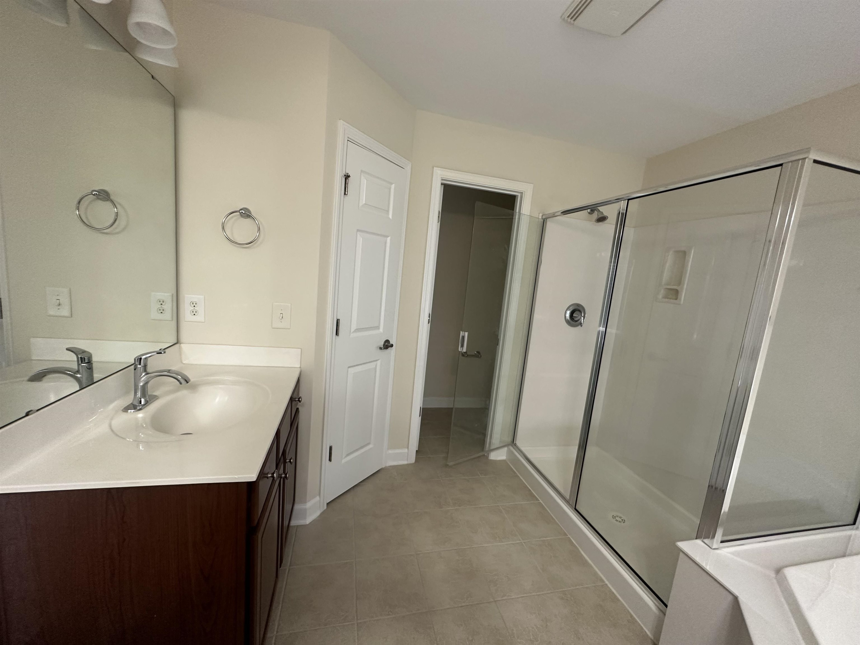 5161 Holly Ridge Farm Road Raleigh, NC 27616 - Photo 24 of 35 a bathroom with a sink a mirror a shower and vanity