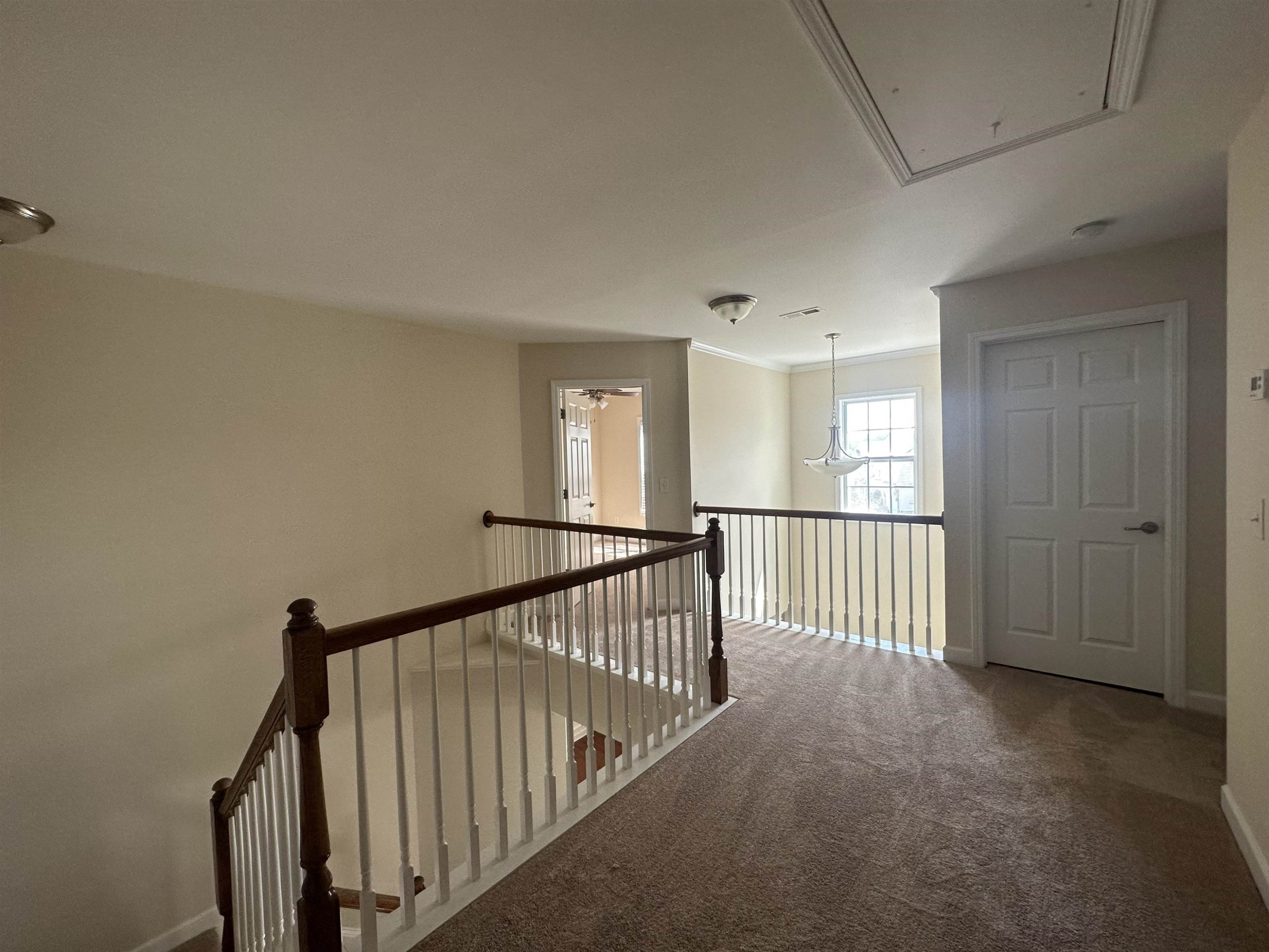 5161 Holly Ridge Farm Road Raleigh, NC 27616 - Photo 26 of 35 a view of a hallway with windows and stairs