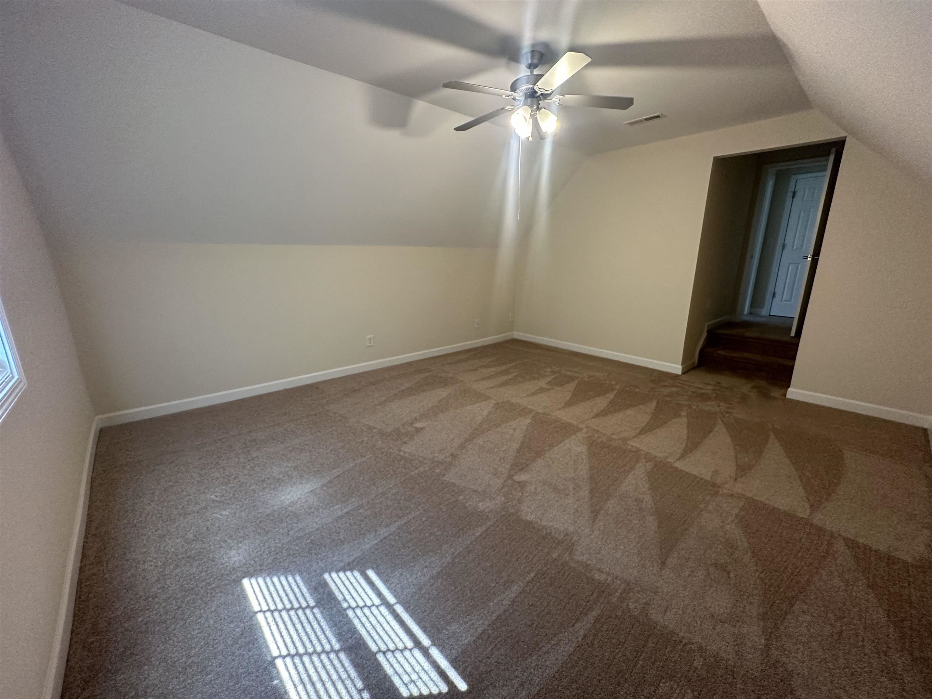 5161 Holly Ridge Farm Road Raleigh, NC 27616 - Photo 30 of 35 an empty room with windows and fan
