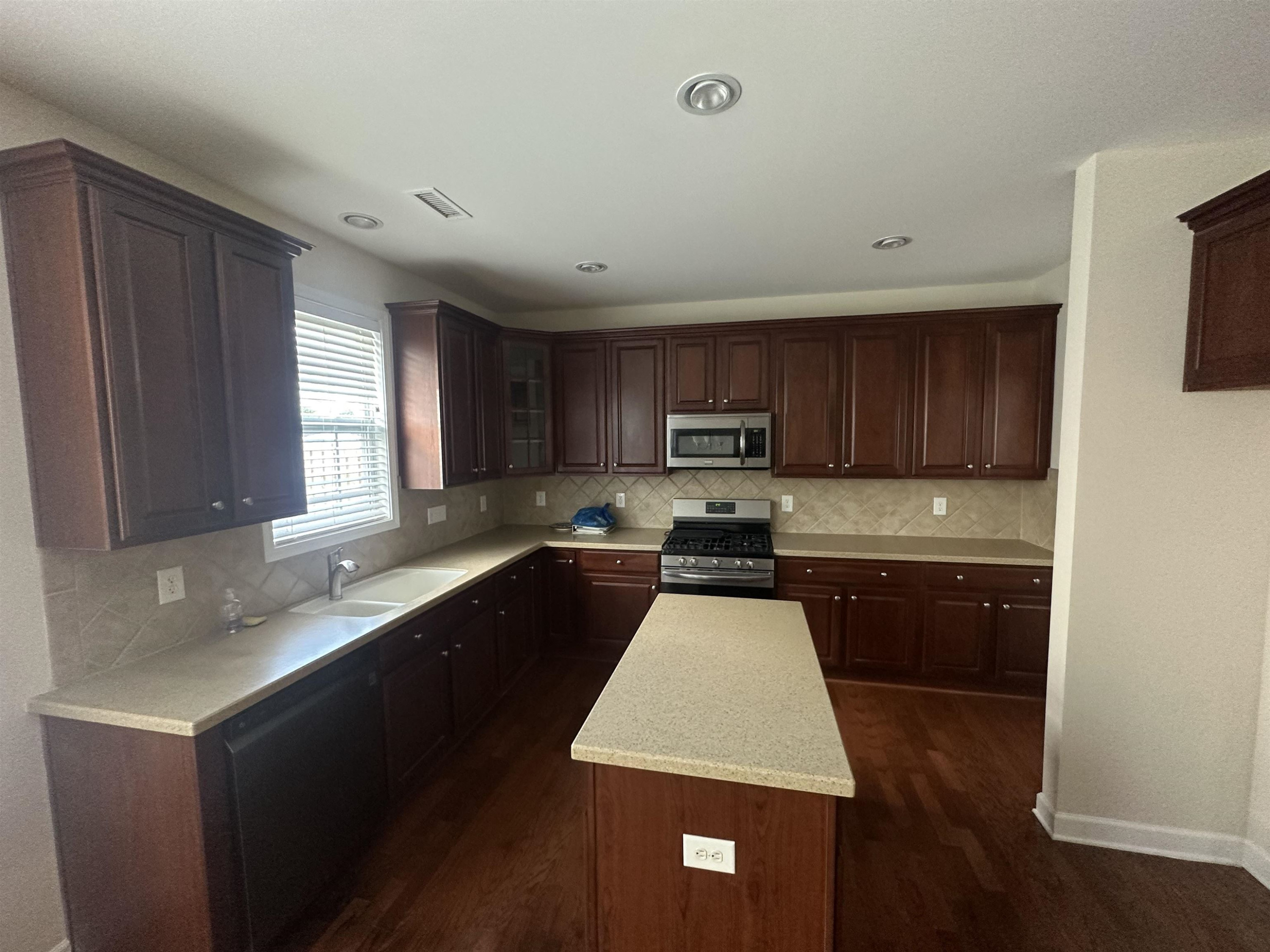 5161 Holly Ridge Farm Road Raleigh, NC 27616 - Photo 10 of 35 a kitchen with granite countertop stainless steel appliances a sink a stove top oven a counter space and cabinets