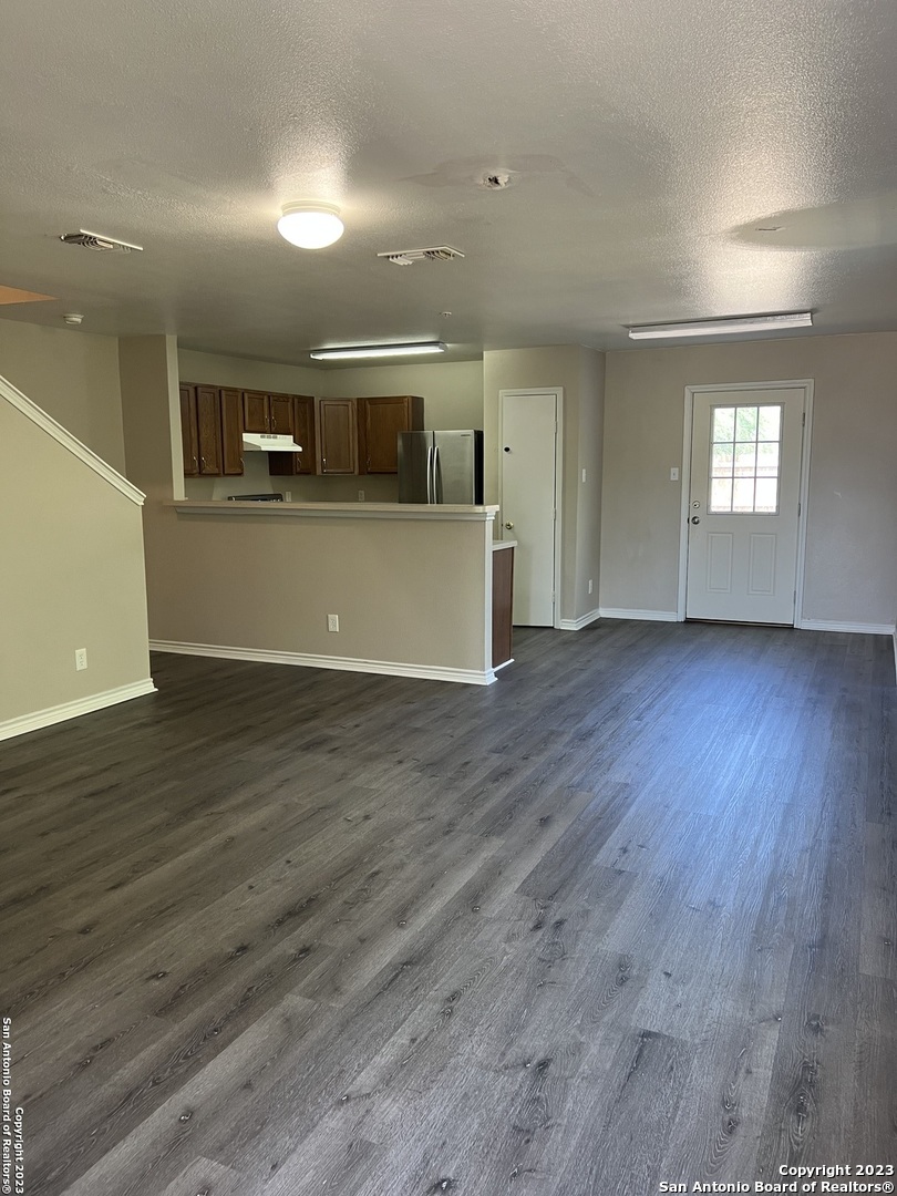 10027 Vasso View, Unit 3 Converse, TX 78109 - Photo 11 of 33 a view of a big room with wooden floor and windows