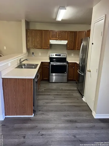 a kitchen with a sink appliances and cabinets
