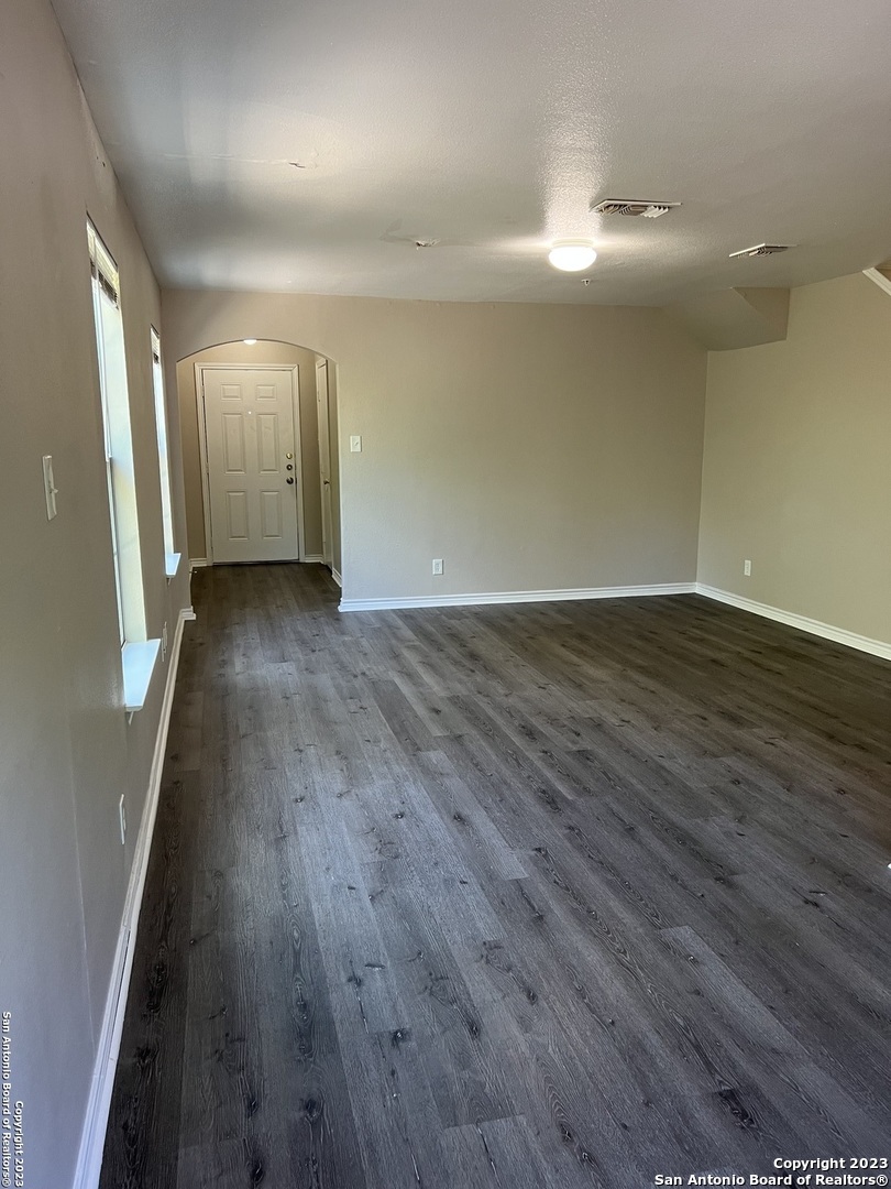 10027 Vasso View, Unit 3 Converse, TX 78109 - Photo 15 of 33 an empty room with wooden floor and windows