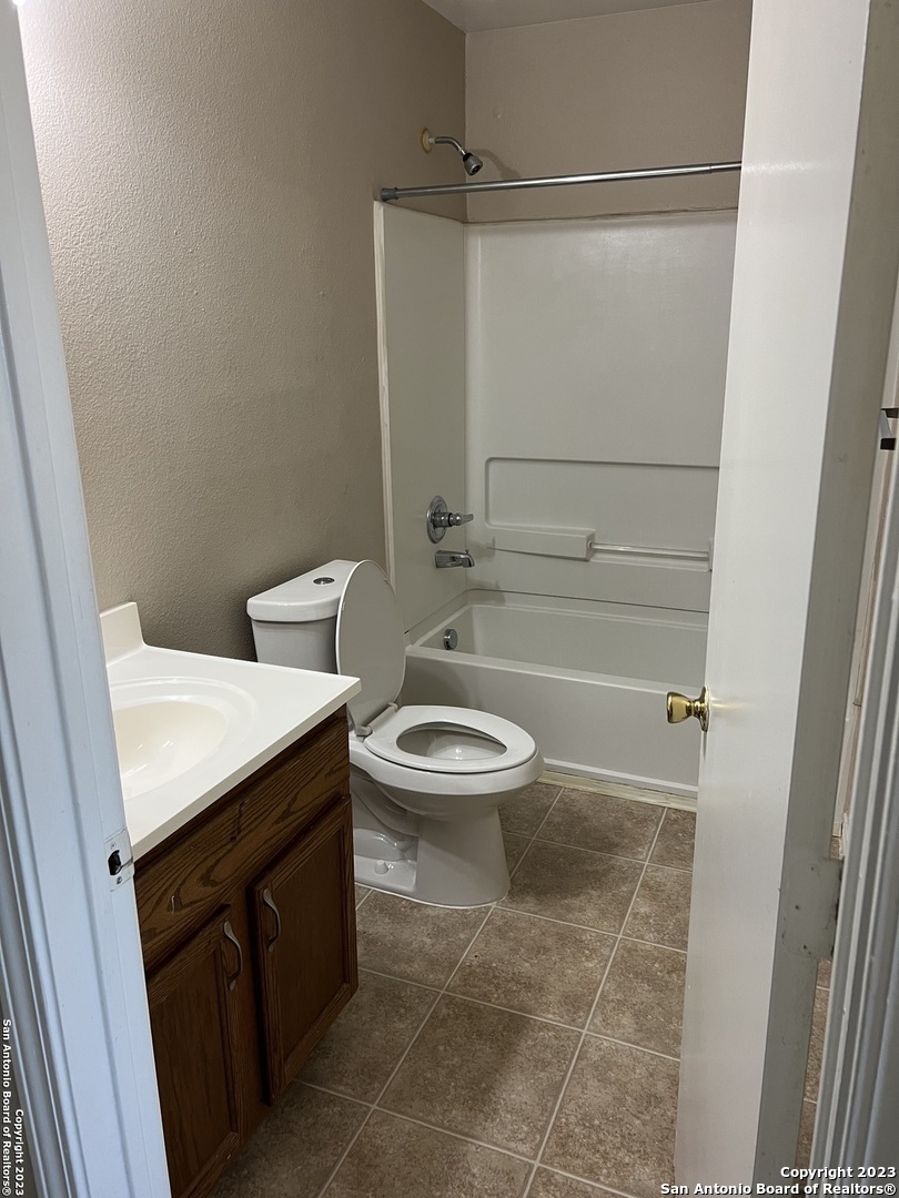 10027 Vasso View, Unit 3 Converse, TX 78109 - Photo 19 of 33 a bathroom with a granite countertop sink toilet and shower