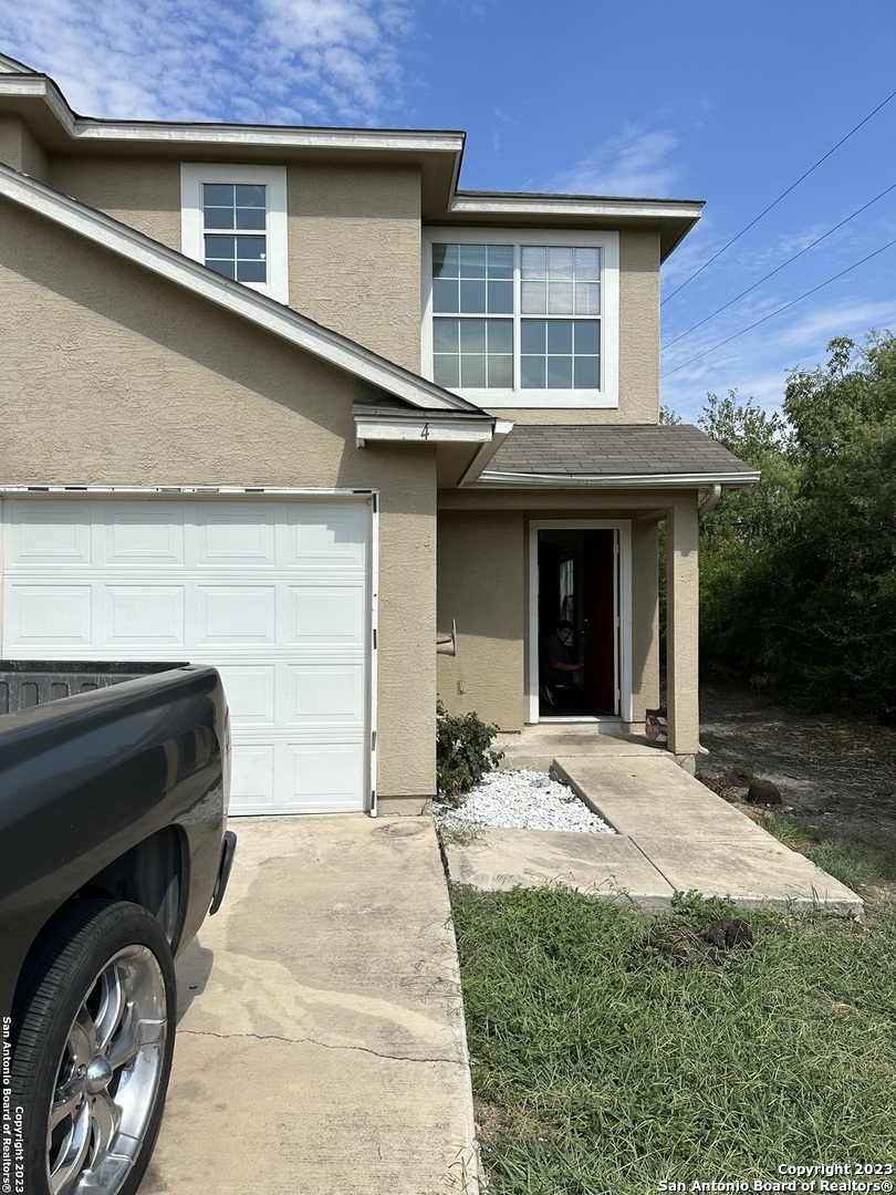 10027 Vasso View, Unit 3 Converse, TX 78109 - Photo 2 of 33 a front view of a house with a yard