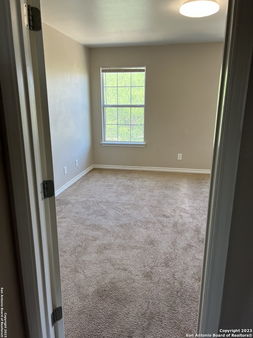 10027 Vasso View, Unit 3 Converse, TX 78109 - Photo 26 of 33 a view of an empty room with a window