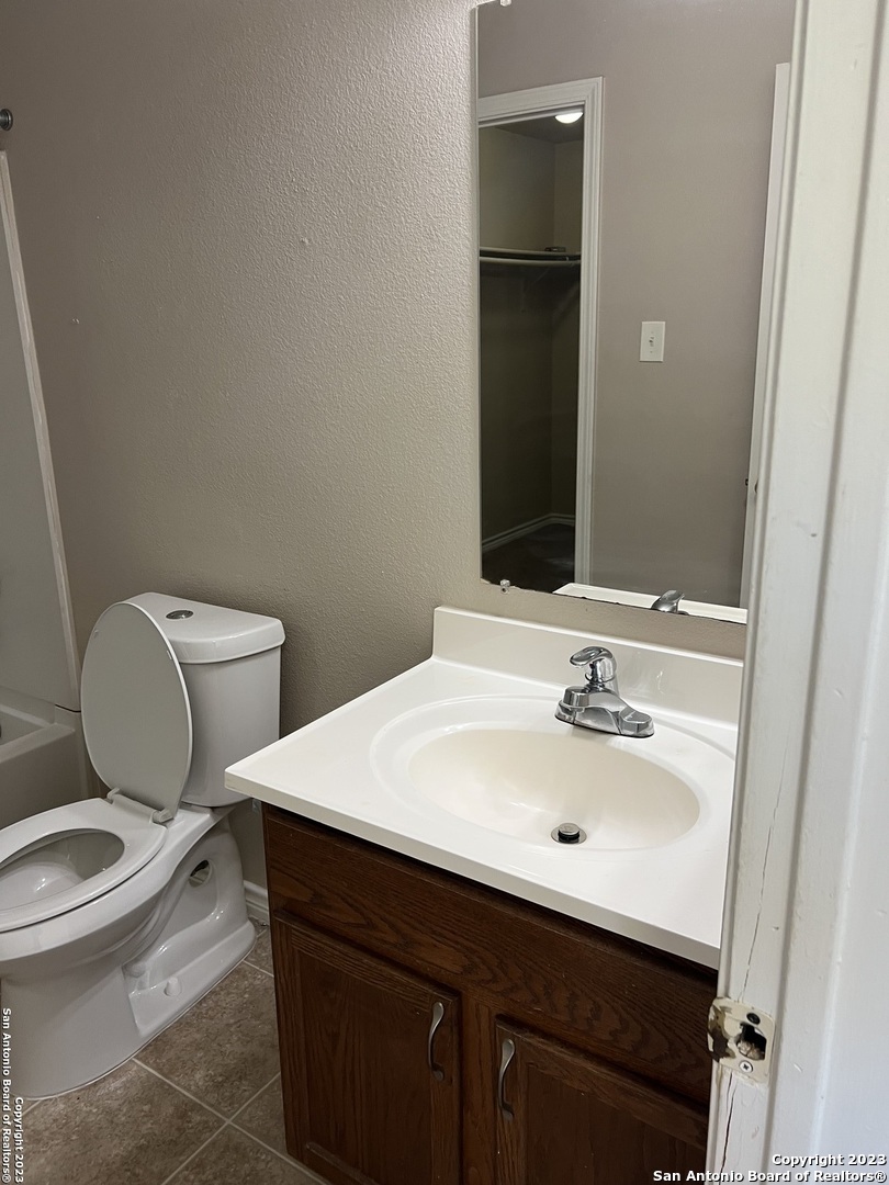 10027 Vasso View, Unit 3 Converse, TX 78109 - Photo 28 of 33 a bathroom with a sink toilet and mirror