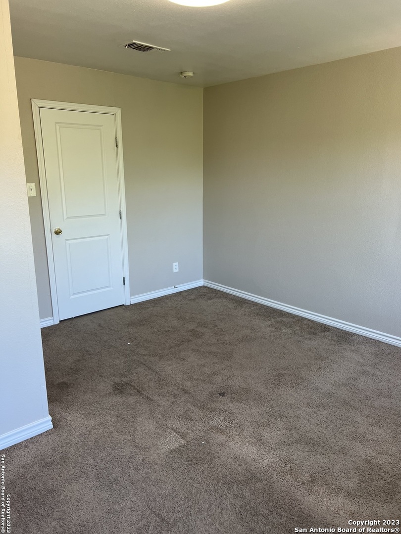 10027 Vasso View, Unit 3 Converse, TX 78109 - Photo 32 of 33 an empty room with a natural light