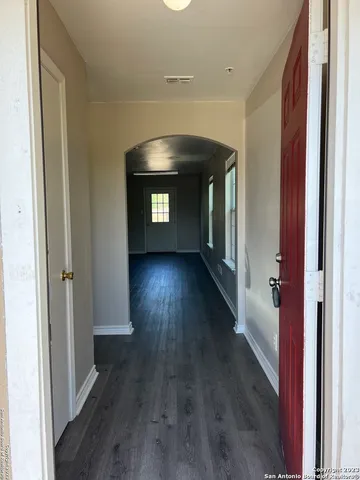 a view of hallway with wooden floor