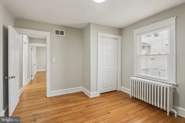 a view of a room with wooden floor and windows