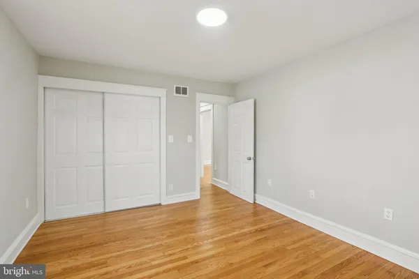 a view of an empty room with wooden floor