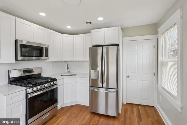 a kitchen with a refrigerator stove and microwave