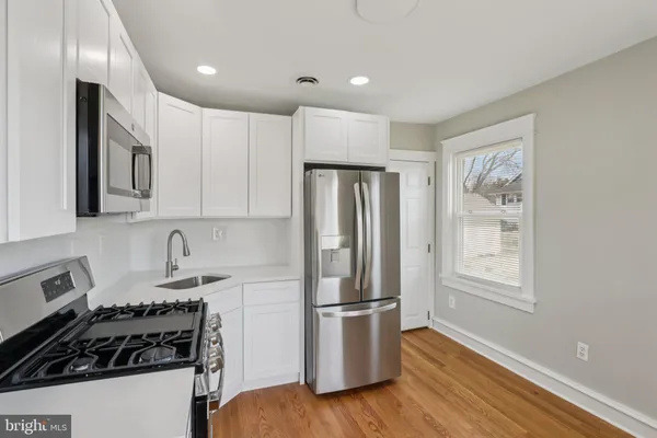 a kitchen with stainless steel appliances granite countertop a refrigerator sink and stove