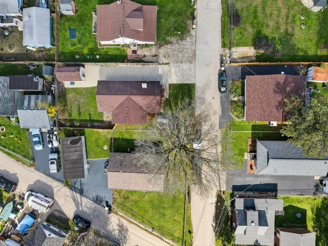 an aerial view of multiple houses with a yard
