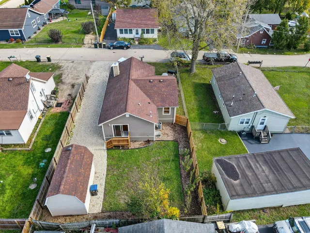 an aerial view of multiple houses with yard