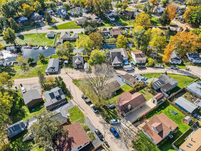 an aerial view of residential houses with outdoor space and swimming pool
