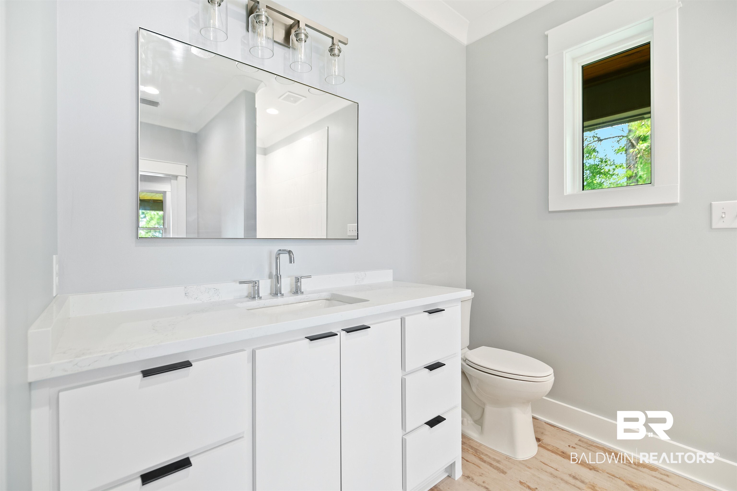 10507 County Road 1 Fairhope, AL 36532 - Photo 23 of 59 Bathroom featuring vanity, wood-type flooring, toilet, and plenty of natural light