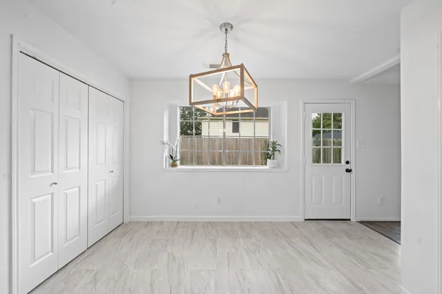 a kitchen with white cabinets stainless steel appliances and sink