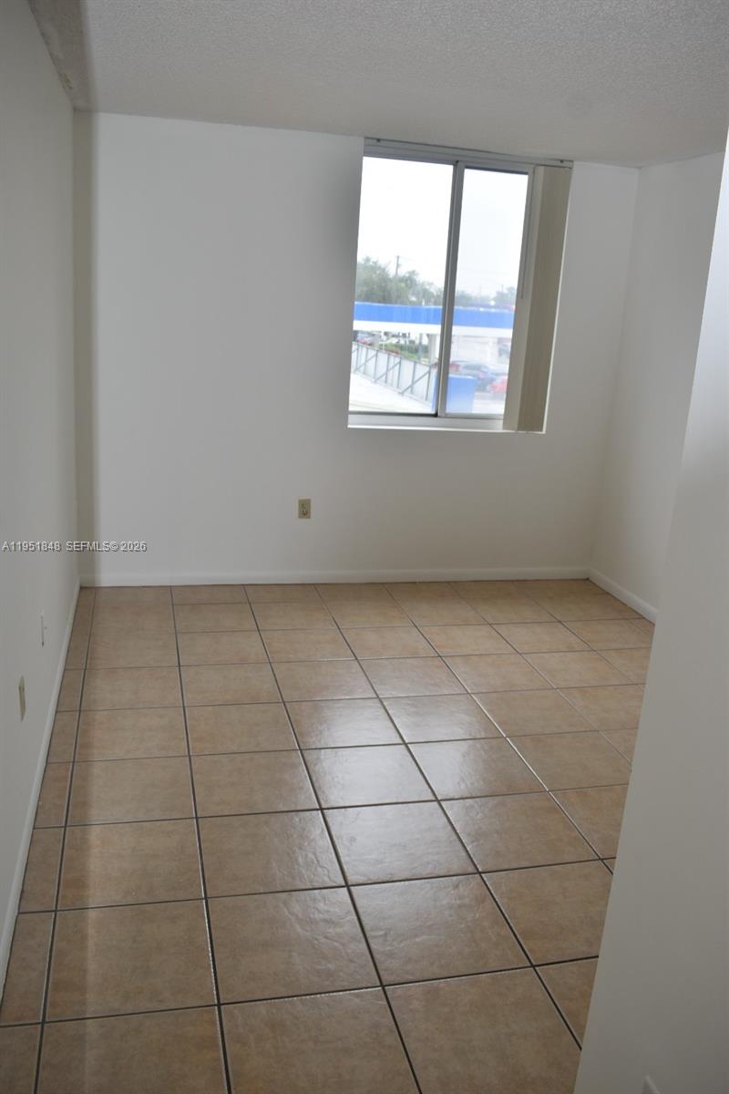 616 Northwest 26th Avenue, Unit 210 Miami, FL 33125 - Photo 11 of 23 a view of a livingroom and window
