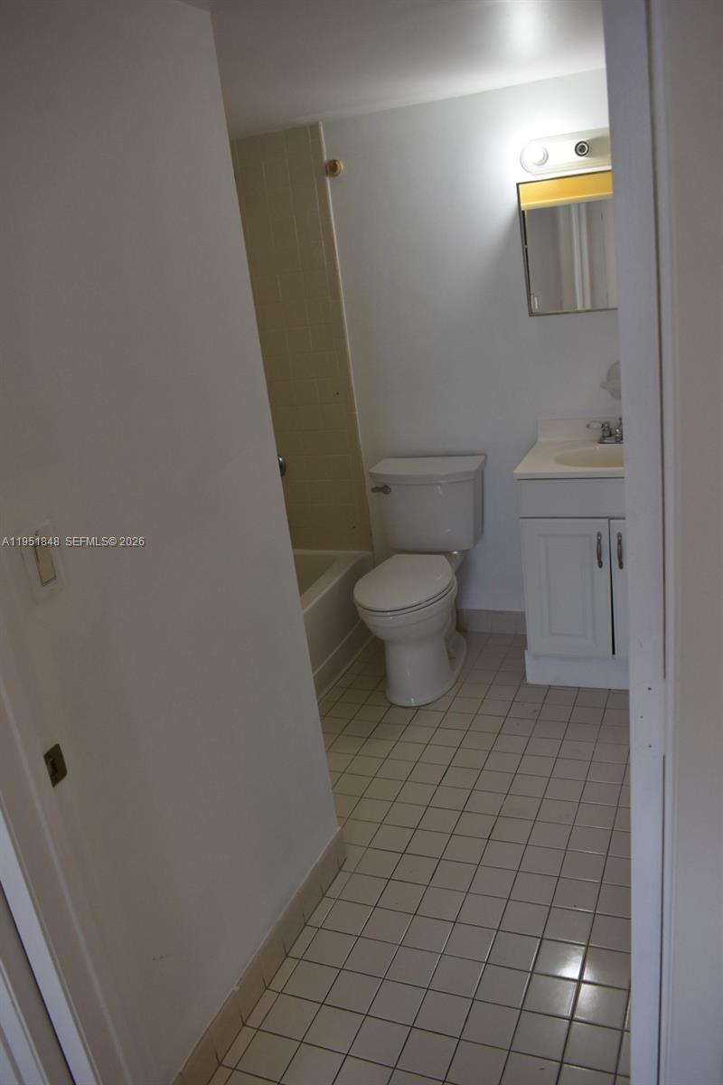 616 Northwest 26th Avenue, Unit 210 Miami, FL 33125 - Photo 15 of 23 a bathroom with a toilet and a sink
