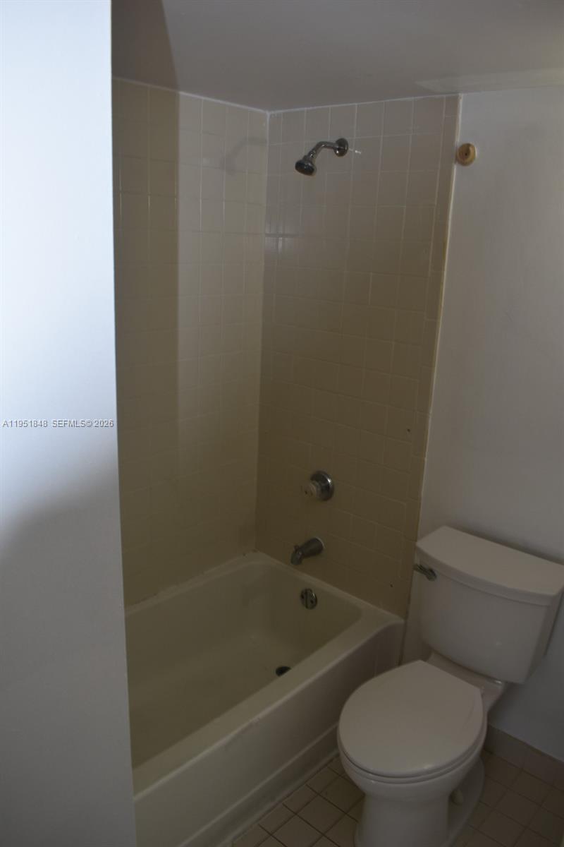616 Northwest 26th Avenue, Unit 210 Miami, FL 33125 - Photo 16 of 23 a white toilet sitting next to a bath tub