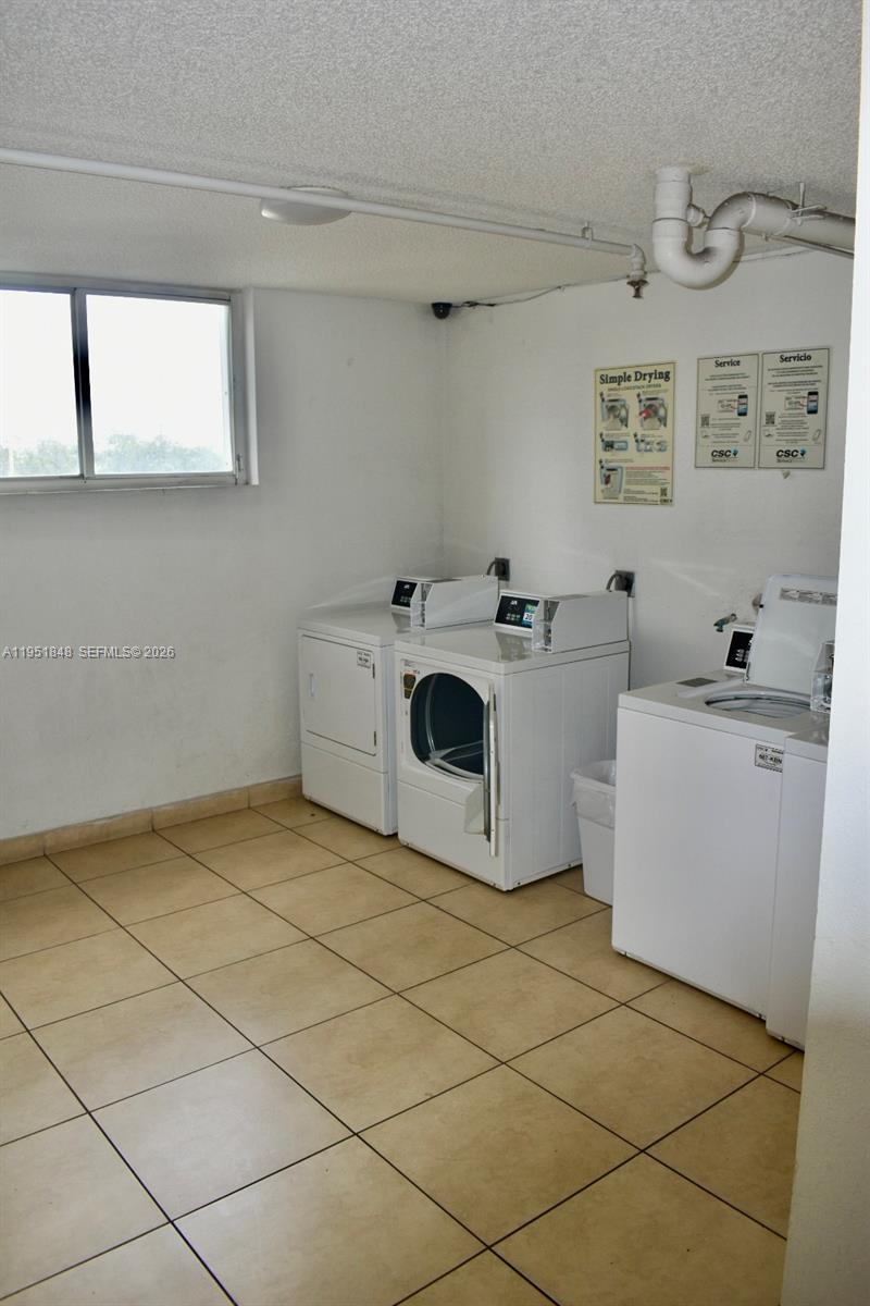 616 Northwest 26th Avenue, Unit 210 Miami, FL 33125 - Photo 20 of 23 a utility room with dryer and washer