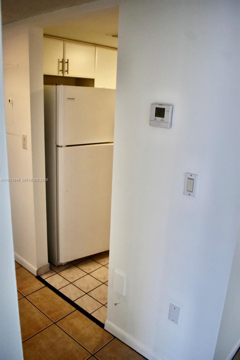 616 Northwest 26th Avenue, Unit 210 Miami, FL 33125 - Photo 7 of 23 a view of a refrigerator in kitchen and an empty room