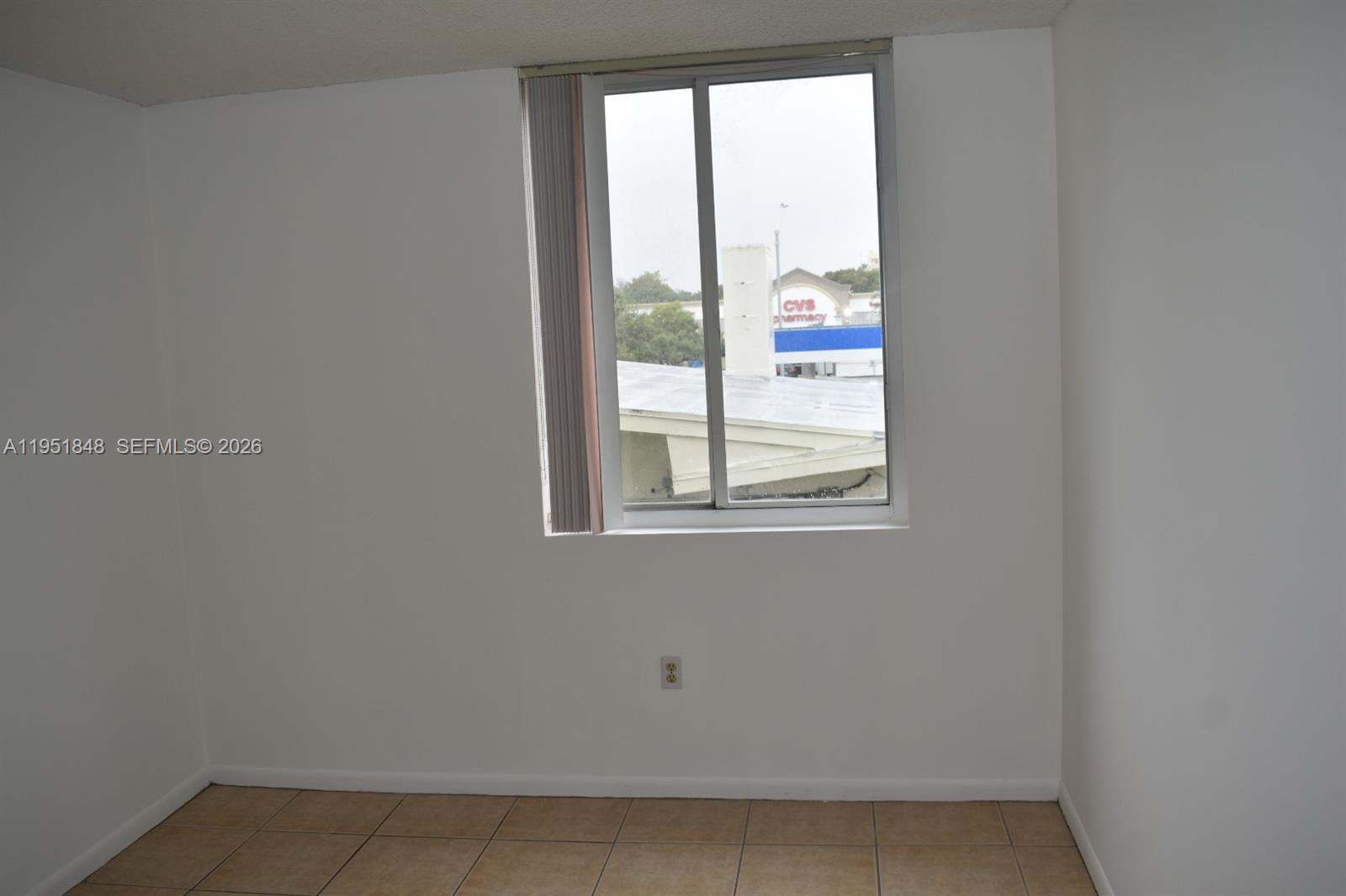 616 Northwest 26th Avenue, Unit 210 Miami, FL 33125 - Photo 9 of 23 a view of an empty room with a window