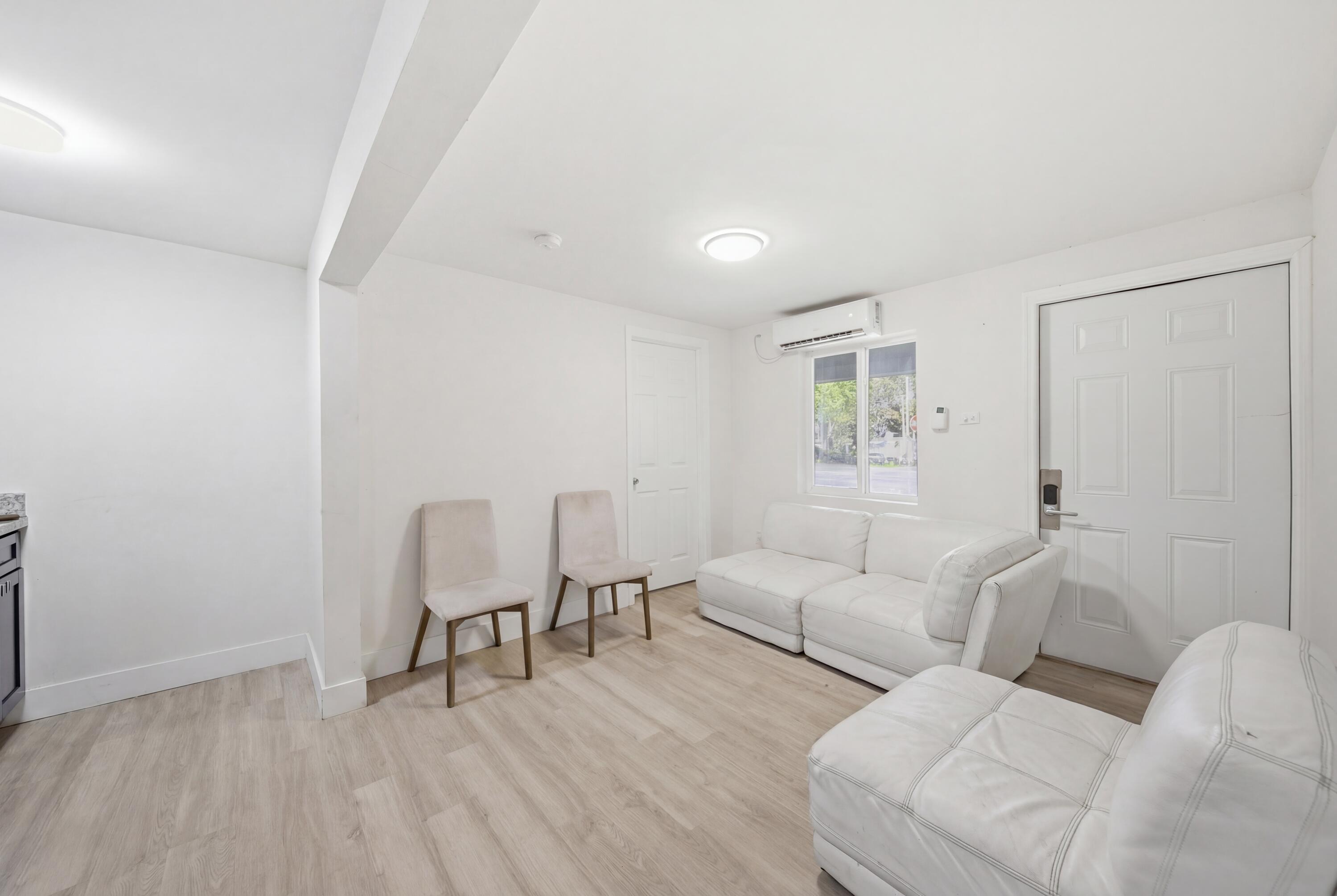 1796 Northwest 112th Street Miami, FL 33167 - Photo 11 of 25 a living room with furniture and a wooden floor