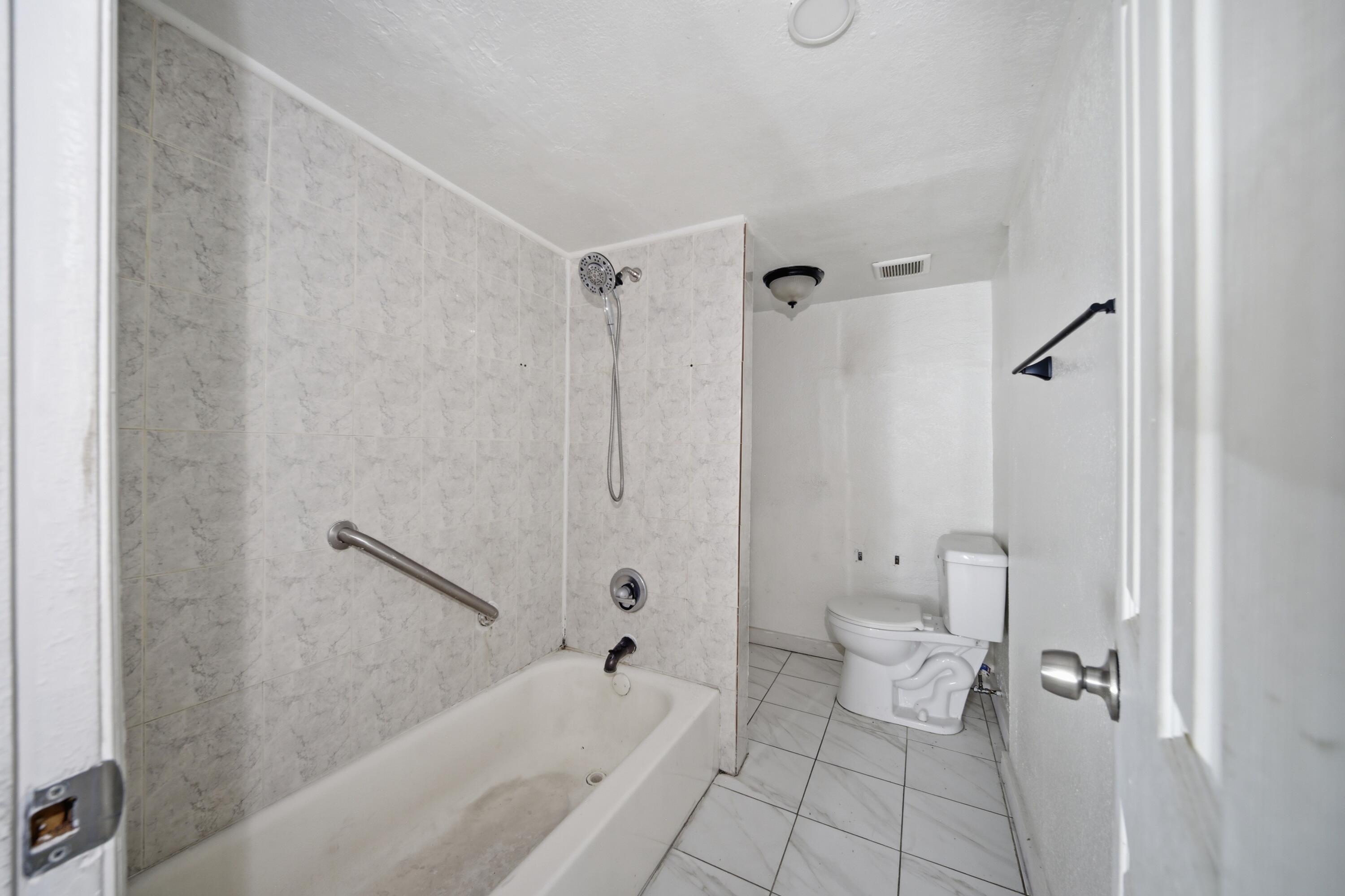 1796 Northwest 112th Street Miami, FL 33167 - Photo 13 of 25 a bathroom with a bathtub and toilet