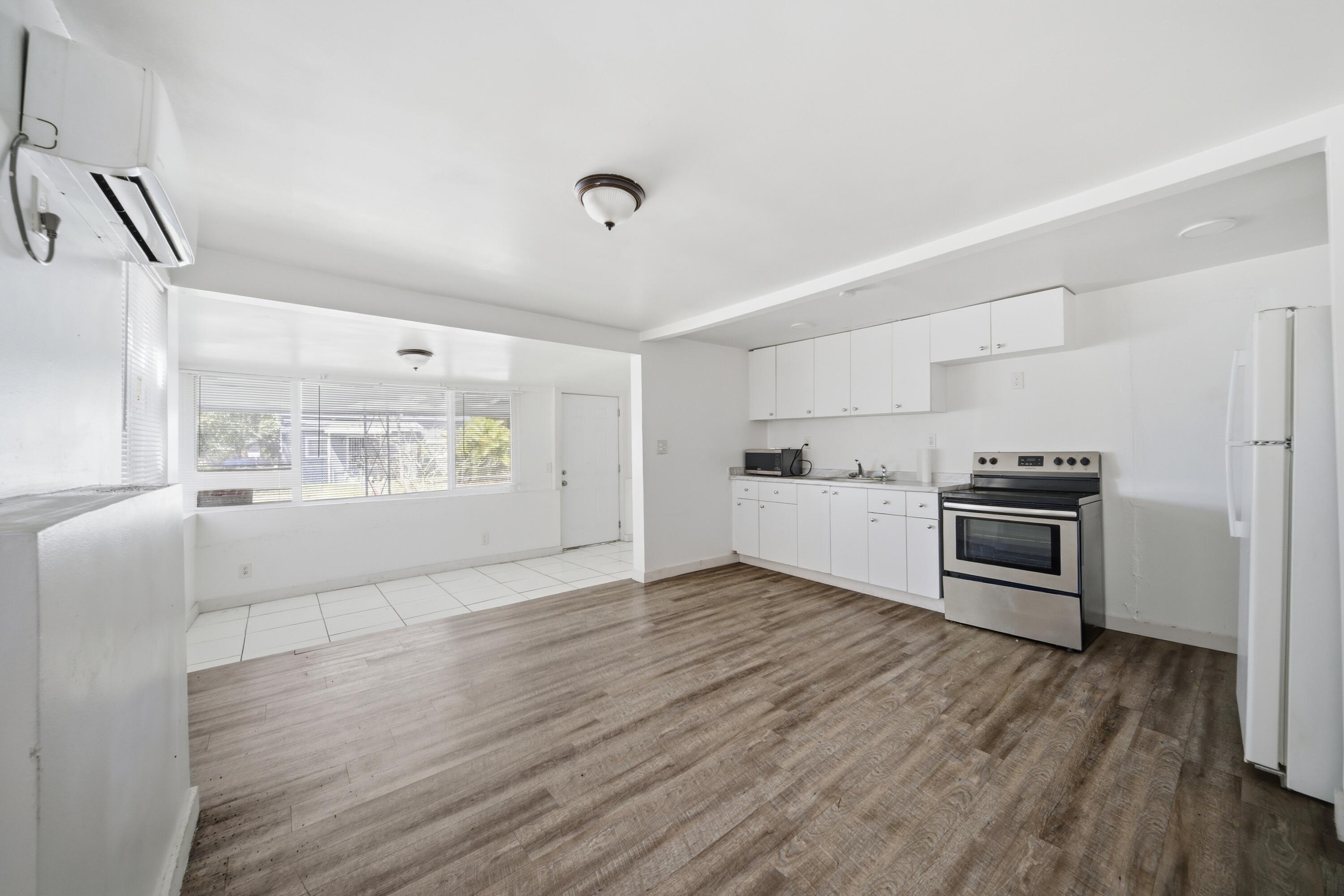 1796 Northwest 112th Street Miami, FL 33167 - Photo 16 of 25 a view of kitchen with wooden floor electronic appliances and window
