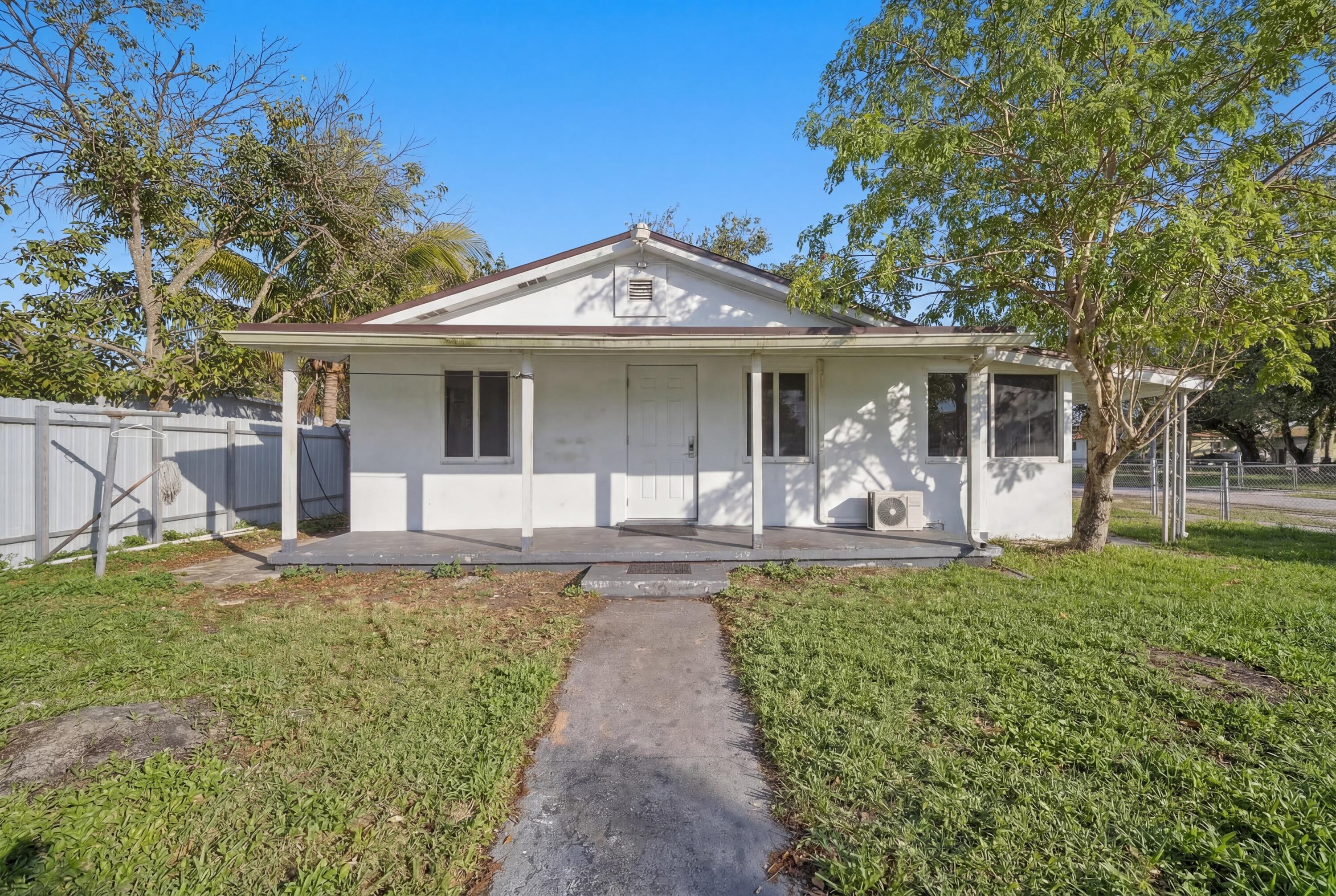 1796 Northwest 112th Street Miami, FL 33167 - Photo 2 of 25 a front view of a house with garden
